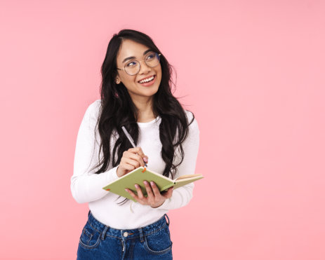 a woman holding a book ang smiling